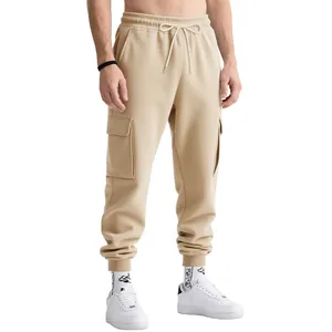 Detail view of khaki cargo sweatpants highlighting side pockets and elastic ankle cuffs