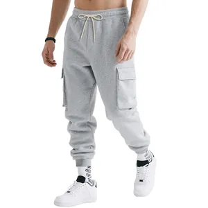 Male model wearing grey heavyweight cargo joggers with multi-pockets and drawstring