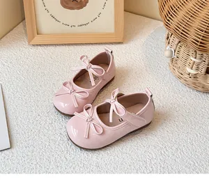 Detailed view of pink patent leather children's Mary Jane shoes with lovely bow ties