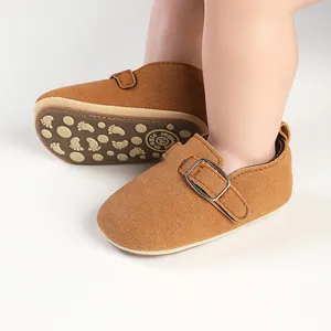 Detailed view of brown faux suede baby Mary Jane flats with buckle and non-slip sole