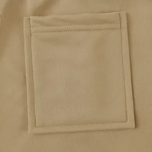 Detailed macro view of a heavy-weight fabric pocket on khaki casual joggers pants.
