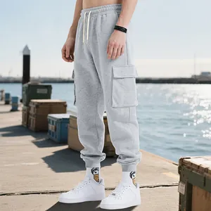 Detail view of men's heavyweight grey cargo sweatpants with multi-pockets on a dock