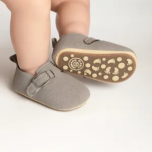 Close-up of grey suede baby Birkenstock shoes with anti-slip sole and buckle detail.
