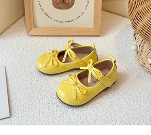 Detailed view of vibrant yellow children's Mary Jane shoes featuring cute bowknots
