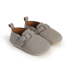 Detailed view of grey suede baby shoes with retro buckle and soft sole