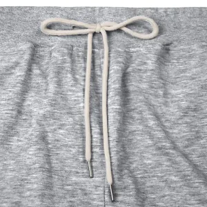 Close-up detail of gray heavyweight sweatpants with an adjustable drawstring waistband