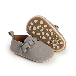 Detailed view of gray suede baby pre-walker shoe with non-slip sole and buckle detail