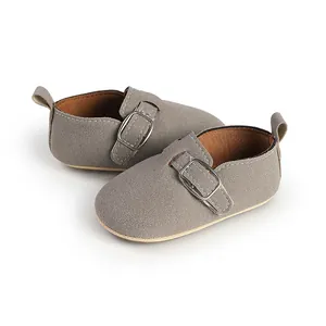 Close-up of vintage gray suede baby shoes with comfortable buckle strap and soft lining