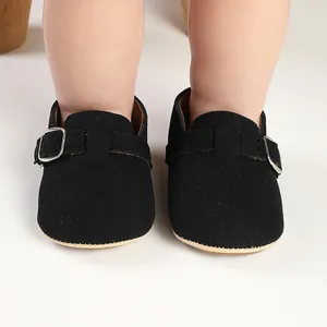 Close-up of retro black matte baby Birkenstock shoes with adjustable buckle strap