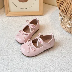 Pink patent leather children's Mary Jane shoes with bow decoration