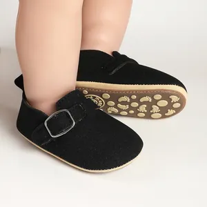 Detail of baby black suede Birkenstock-style shoes with non-slip foot pattern sole