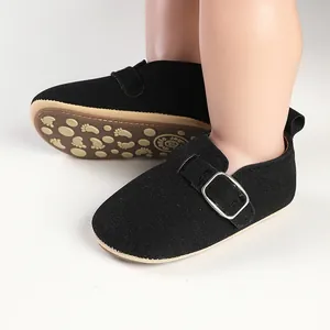 Detail of retro black baby Birkenstock-style flats with silver buckle and non-slip sole