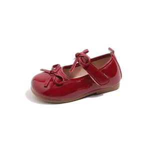 Elegant glossy red Mary Jane shoes for girls with cute double bow details and soft soles