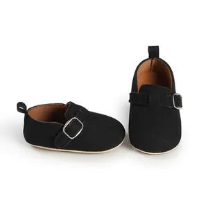 Detail shot of black matte vintage infant flats featuring a stylish single buckle strap