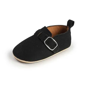 Detailed view of black matte retro baby flat shoe featuring a metallic buckle strap.