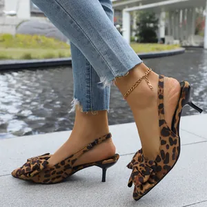 Close-up of stylish leopard print kitten heel slingback sandals with bow detail