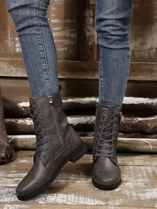 Modische graue Schnürstiefel mit seitlichem Reißverschluss auf rustikalem Holz