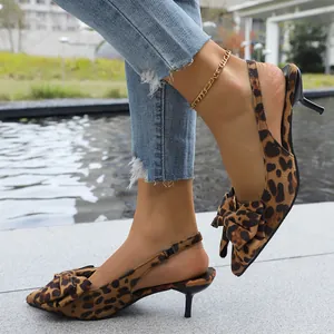 Close-up view showing leopard print fabric and bow detail on slingback kitten heel sandals