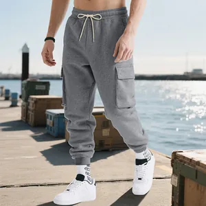 Men's grey heavyweight cargo sweatpants with drawstring waist in a street style view
