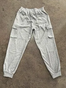 Rear view of grey heavyweight cargo sweatpants with multi-pockets and elastic waist.
