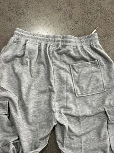 Detailed view showing the back pocket and elastic waistband on heavy grey cargo sweatpants