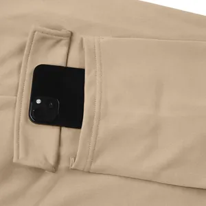 Detail of a khaki men's cargo pants pocket showing its large capacity for a smartphone.