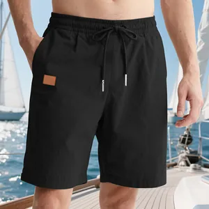 Close-up of men's black summer beach shorts featuring adjustable drawstring elastic waist