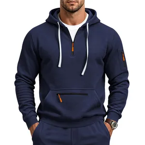 Detail view of men's navy blue quarter-zip hoodie with orange accents and pocket