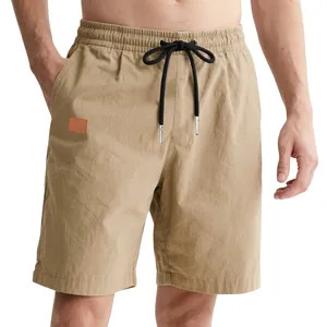 Detail of men's khaki casual shorts with black drawstring and elastic waist