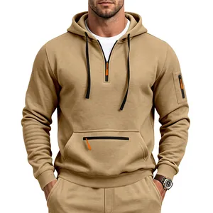 Khaki men's quarter-zip hoodie detail with orange zipper pulls and pocket design