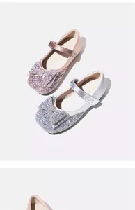 Close-up detail of sparkly glitter princess shoes for girls with elegant bow accent