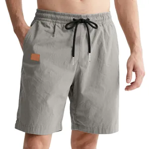 Detail view of grey casual men's shorts showing elastic waist and black drawstring
