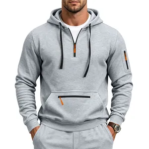 Detailed view of a grey men's heavy fleece half-zip hoodie with orange zipper accents.