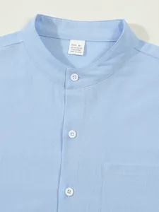 Detail view of a light blue men's stand collar shirt with textured fabric and buttons
