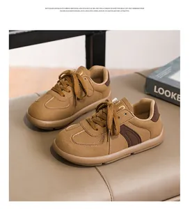 Classic brown suede German army trainers for women displayed on a leather bench detail
