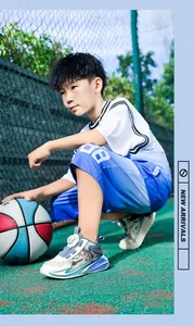 Close-up of boys' stylish blue and white basketball shoes with rotary buckle on court