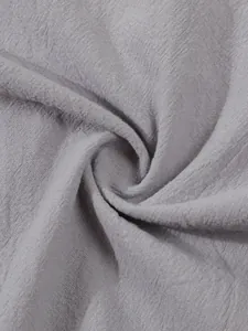 Close-up of light gray breathable cotton linen fabric texture with natural fibers