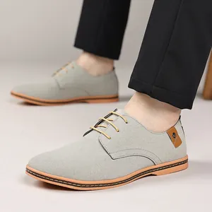 Detailed side view of men's grey nubuck leather casual shoes with tan laces on model