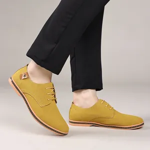 Side view of yellow suede men's casual lace-up shoes paired with black trousers