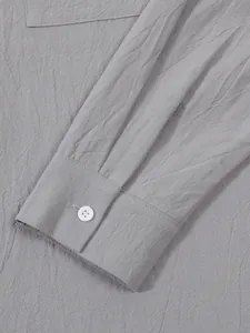 Macro view of grey linen cotton shirt cuff showing fine fabric texture and white button