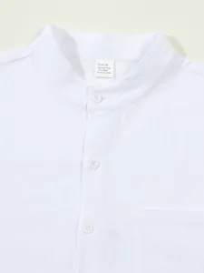 Close-up of a white cotton-linen shirt featuring a Mandarin collar and fabric label