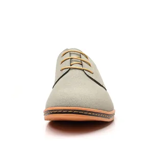Elegant grey suede men's oxford shoes featuring stylish yellow laces on a white background