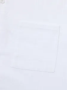 Close-up macro view of white cotton-linen shirt fabric texture and front pocket detail