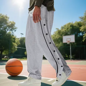 Detalle lateral de pantalones de baloncesto hip-hop grises con botones de presión laterales