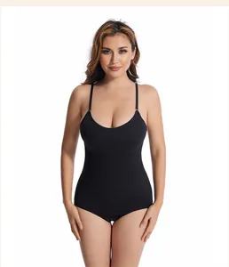 Front view detail of a black seamless tummy control shapewear bodysuit on a model