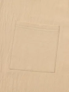 Detailed view of the square pocket and textured cotton linen fabric on this beige shirt