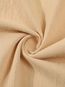 Close-up of breathable beige cotton linen fabric showing natural weave texture