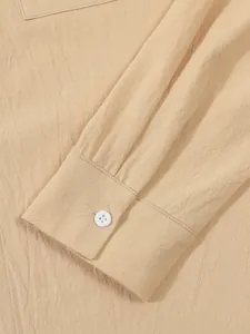 Close-up of beige cotton linen shirt cuff showing textured fabric and white button