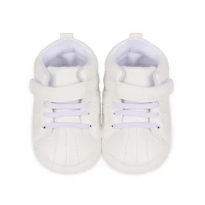 Top view of white high-top baby toddler shoes with soft soles and velcro strap.
