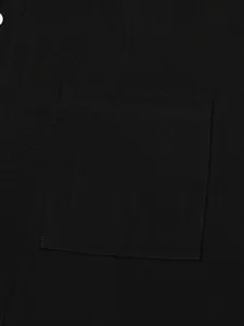 Macro detail of black cotton linen shirt showing fabric texture and front pocket stitching